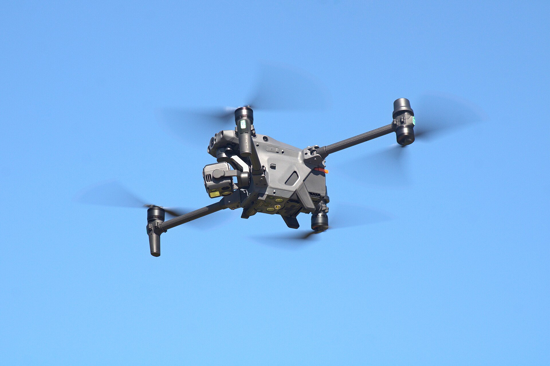 DJI Matrice 30T in flight, multi-sensor gimbal with zoom and thermal apertures on the nose