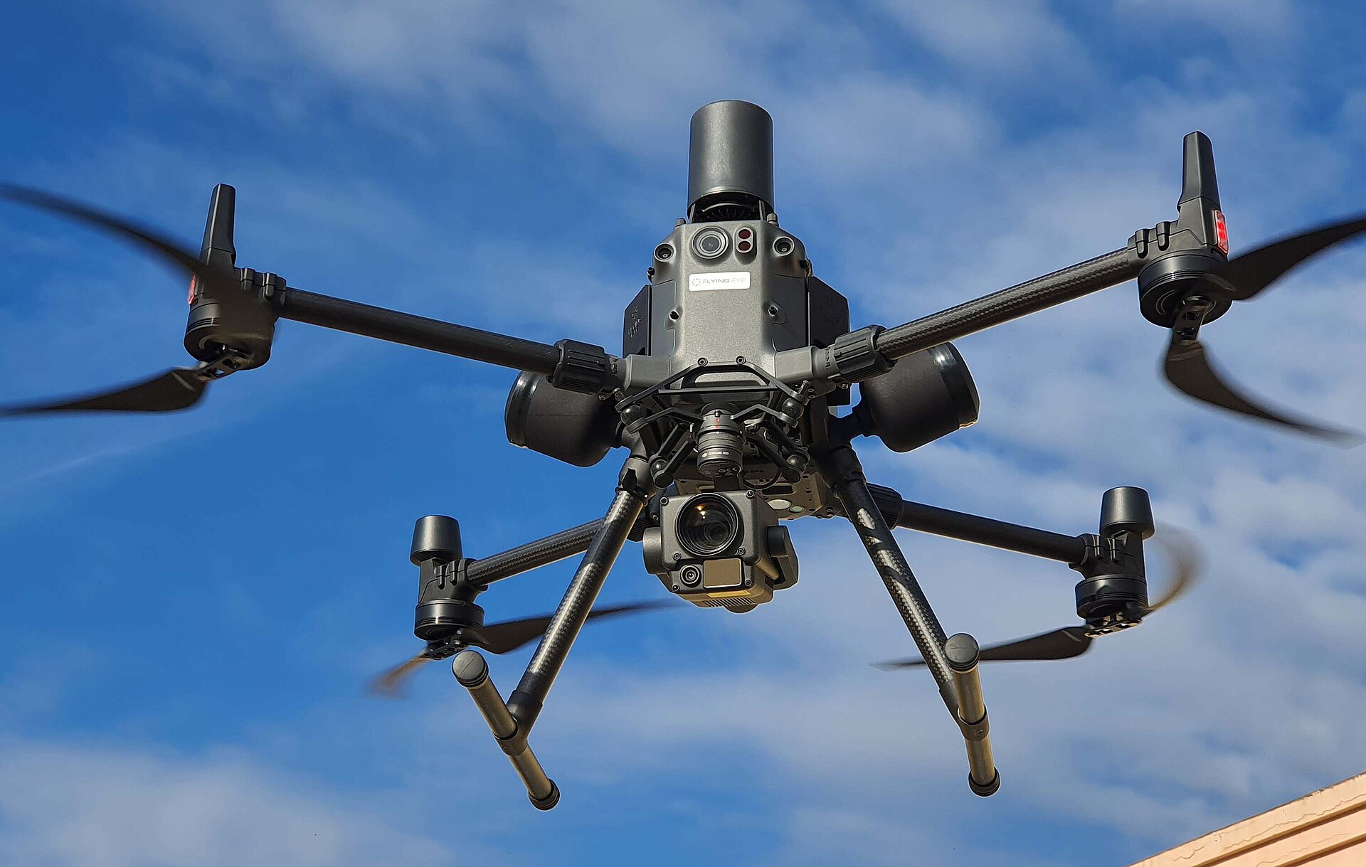 DJI Matrice 300-series RTK enterprise quadcopter in flight with underslung Zenmuse zoom gimbal