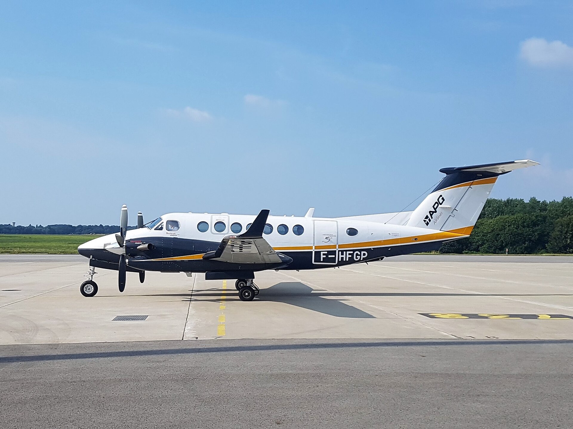 Beechcraft King Air 350 twin turboprop on the apron, winglets and stretched cabin window line visible
