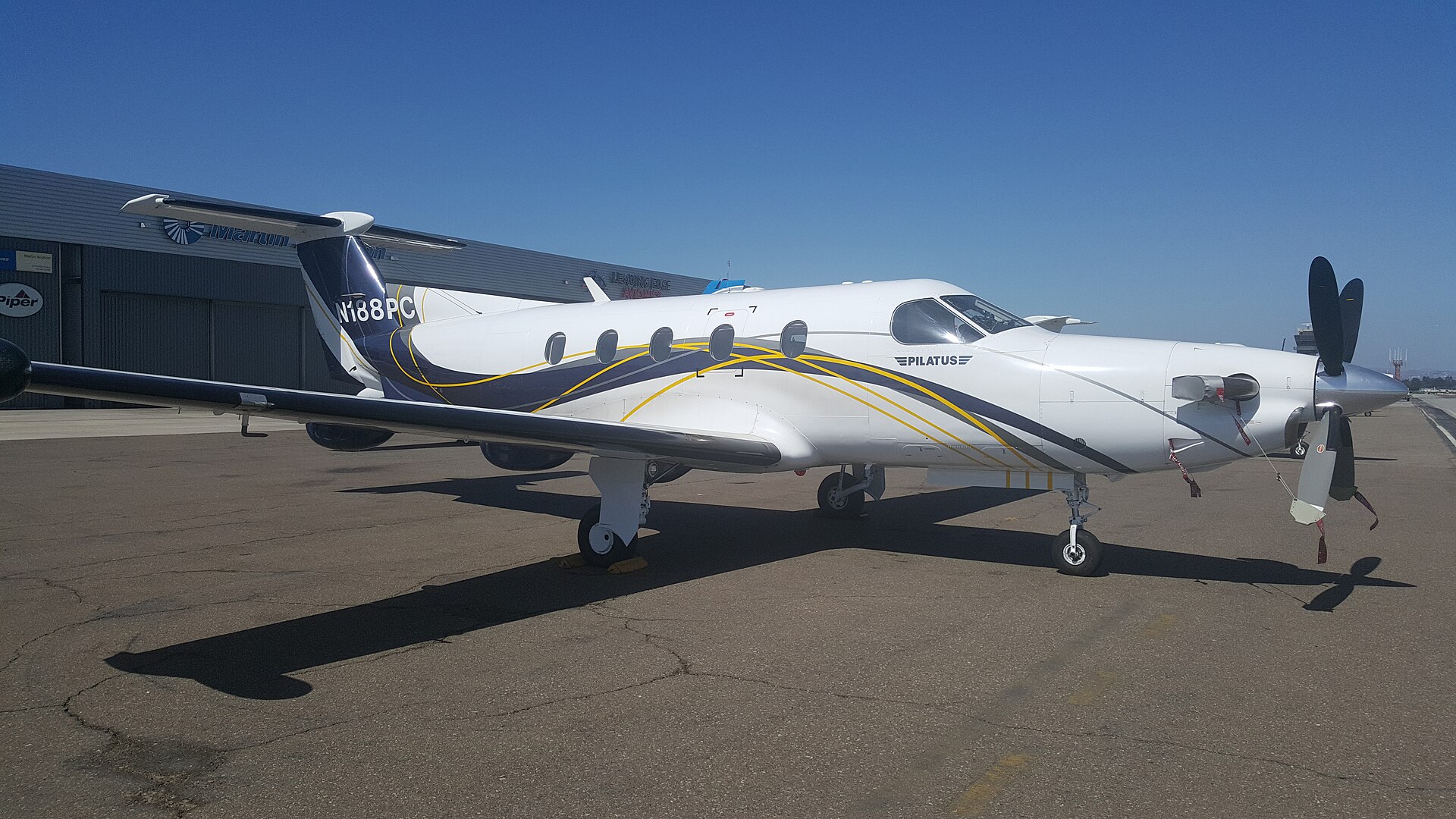 Pilatus PC-12 single-engine turboprop on the ramp, low wing, T-tail and long pointed nose