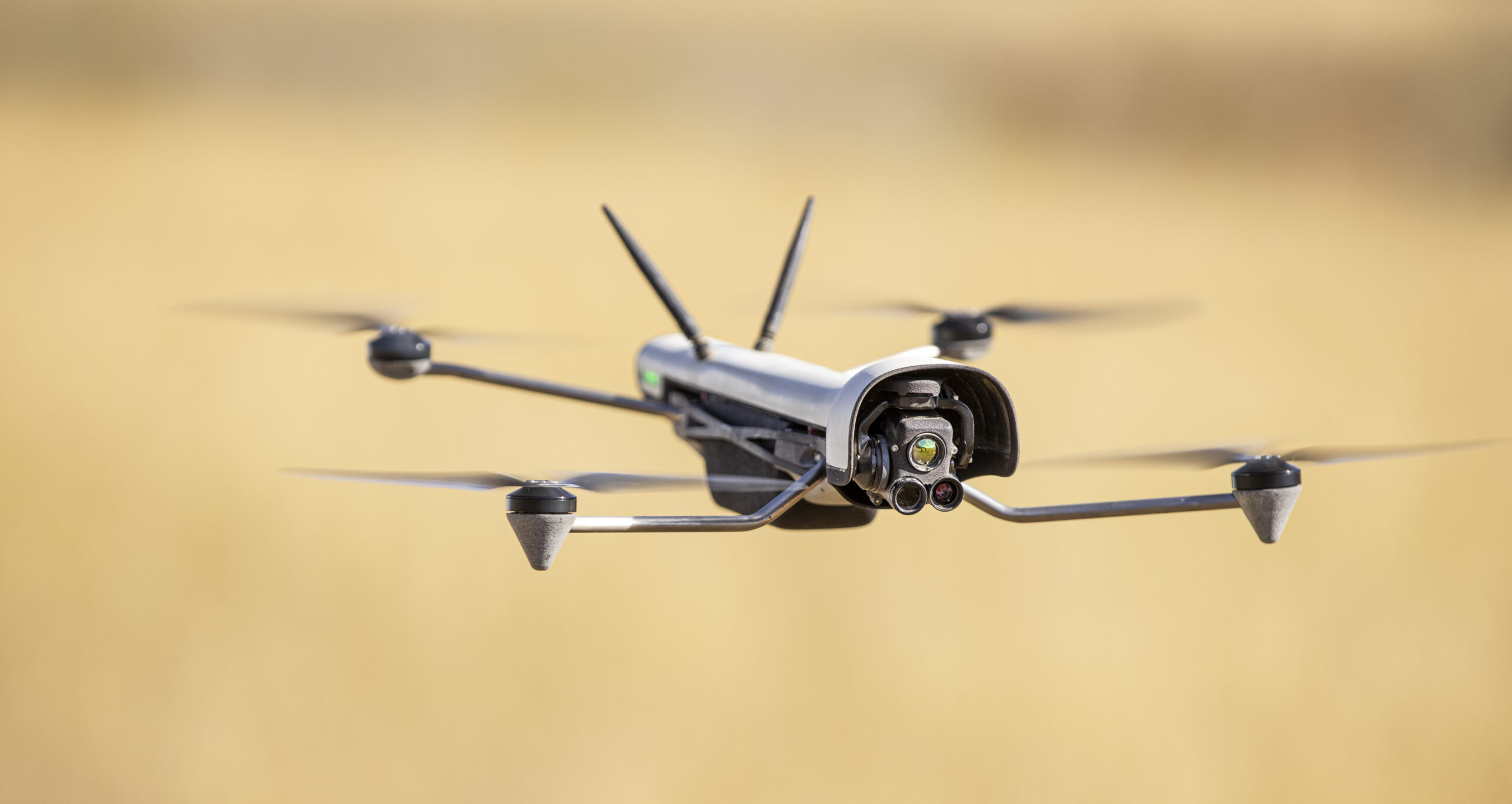 Vantage Robotics Vesper compact ISR quadcopter in flight with tri-lens nose gimbal and twin rear antennas