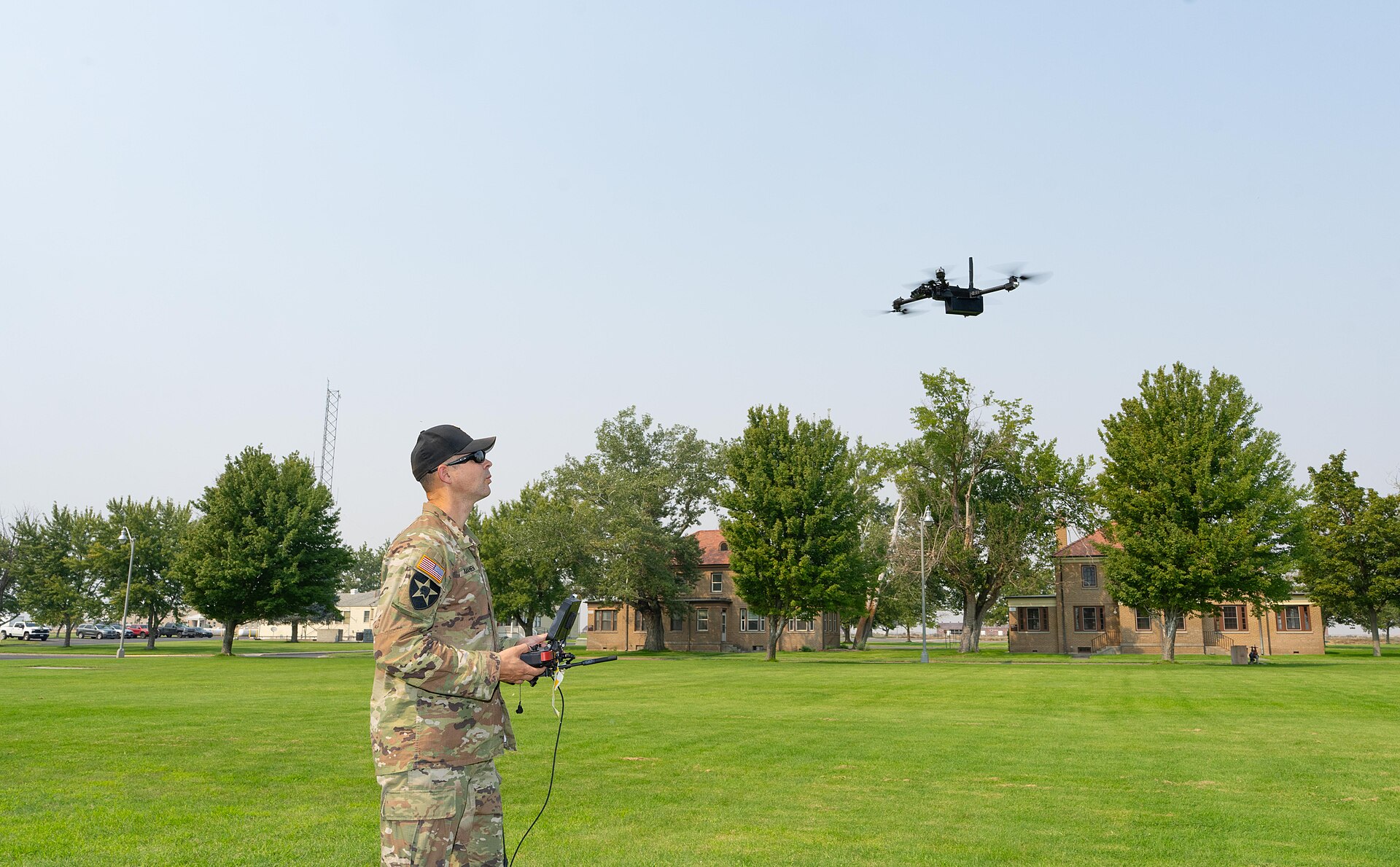 UAS operator flying a quadcopter with a handheld ground-control station during flight operations